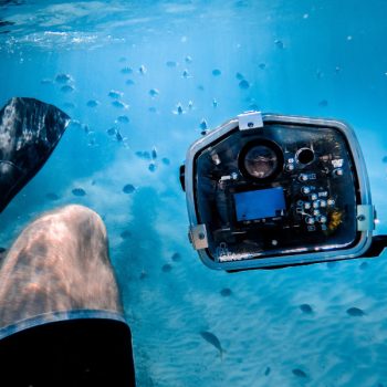 This picture shows a diver with an underwater camera. The picture is featured by your Gili Meno dive center Divine Divers. Diving Gili Islands for beginners and experts. Fun Diving and courses and introduction dives. Accommodation and healthy restaurant on Gili Meno.