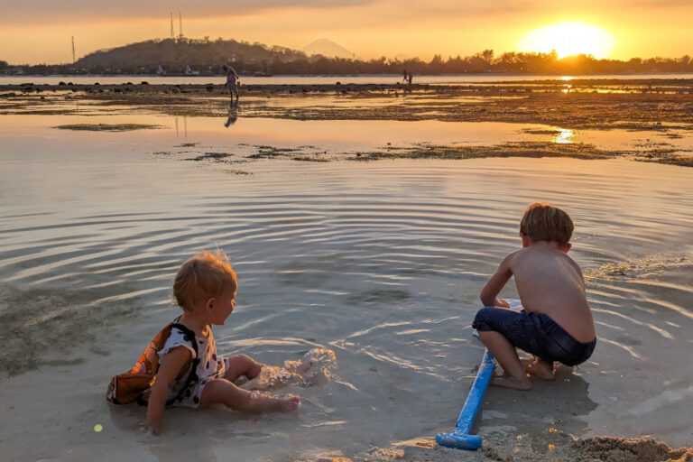 This picture shows two kids playing int he shallow waters of Gili Meno.